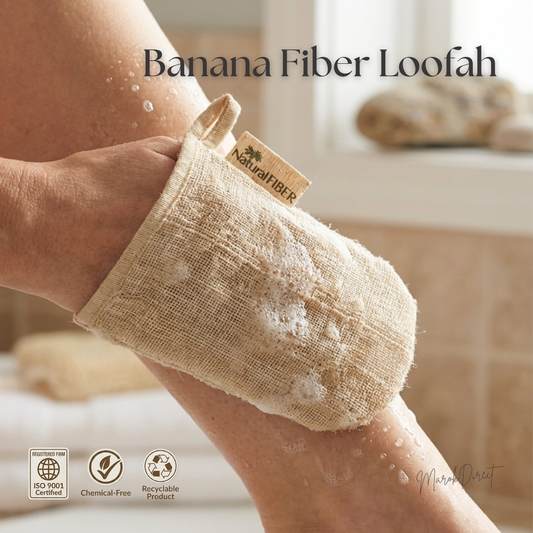 Close up of a person using a natural banana fiber loofah on their leg, creating soapy lather.